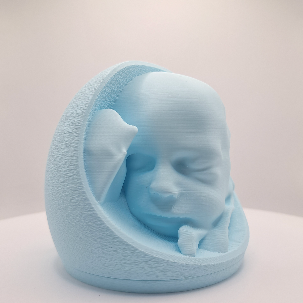 A pastel blue 3D printed baby head in a belly, shown on a neutral light gray background.